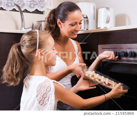 Woman and child cooking strudel 21595969