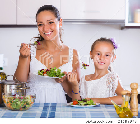 Woman and girl holding salad Woman and girl holding salad 21595973
