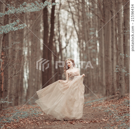 Beautiful girl in blooming spring garden 21596434