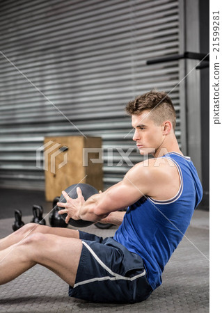 Muscular man training with medicine ball Muscular man training with medicine ball 21599281