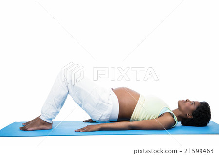 Pregnant woman doing exercise on mat 21599463