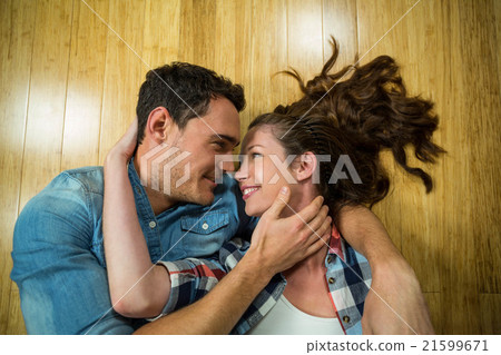 Young couple lying on floor in their house Young couple lying on floor in their house 21599671