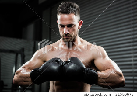 Angry shirtless man with boxe gloves Angry shirtless man with boxe gloves 21599673