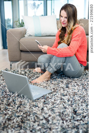 smiling woman on her laptop and mobile phone smiling woman on her laptop and mobile phone 21599680