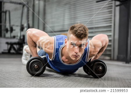 Muscular man doing push up with dumbbells Muscular man doing push up with dumbbells 21599953