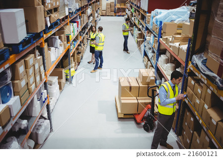 Warehouse worker using hand scanner 21600121