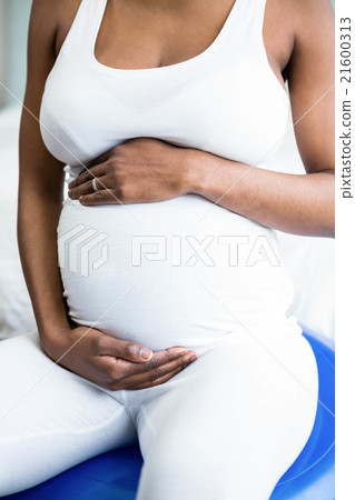 Pregnant woman rubbing her belly 21600313