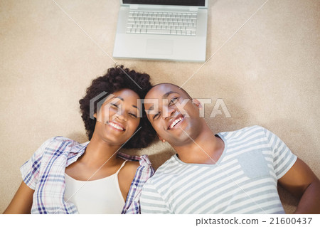 Happy couple lying on the floor 21600437