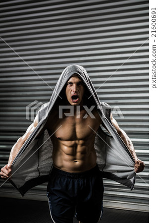 Shirtless man with grey jumper shouting Shirtless man with grey jumper shouting 21600691