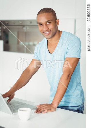 Handsome man using laptop Handsome man using laptop 21600886
