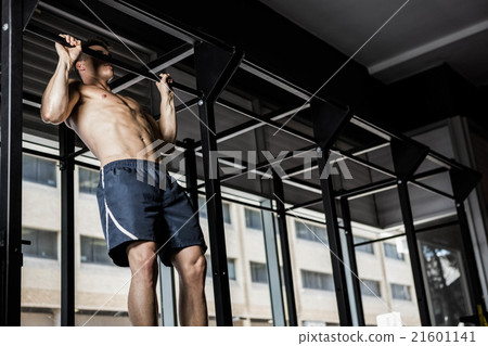 Shirtless man doing pull up 21601141