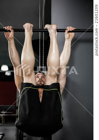 Shirtless man doing pull up 21601209