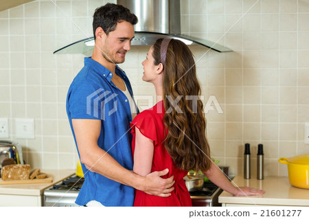 Romantic couple standing face to face and embracing each other 21601277