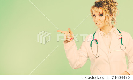 Female doctor showing copy space. Female doctor showing copy space. 21604450
