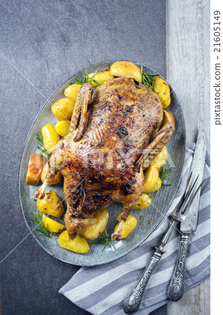 Roasted Duck with Quince, Potato and Apples on a P 21605149