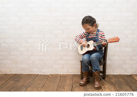 Girl playing guitar 21605776