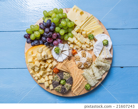 Cheese plate variation on a wooden blue table Cheese plate variation on a wooden blue table 21607243