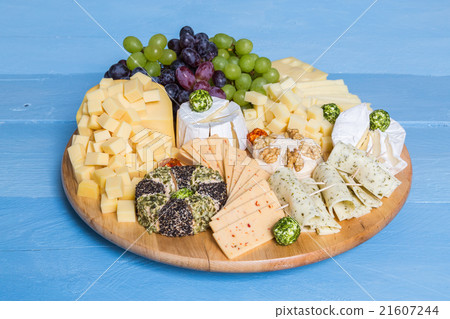 Cheese plate variation on a wooden blue table Cheese plate variation on a wooden blue table 21607244