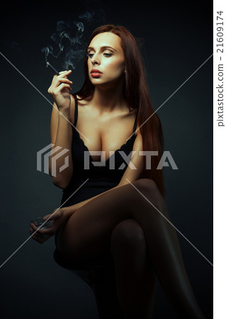 attractive sexy girl with cigarette dark scene attractive sexy girl with cigarette dark scene 21609174