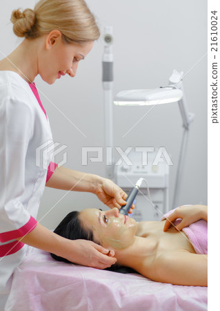 Young beautiful woman with dark hair gets Young beautiful woman with dark hair gets 21610024