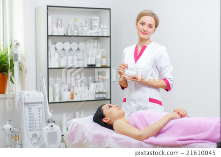 Young woman beautician is doing the cleaning Young woman beautician is doing the cleaning 21610045