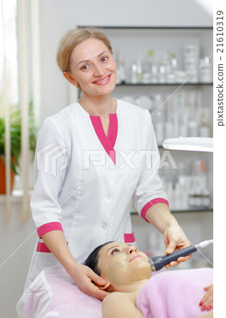 Young woman beautician is doing the cleaning Young woman beautician is doing the cleaning 21610319