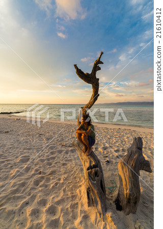 Woman on the beach at sunset Woman on the beach at sunset 21610412