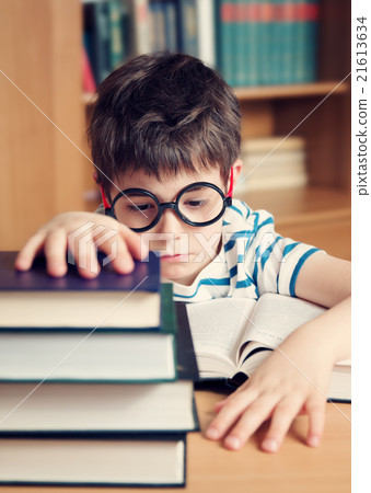 seven years old child reading a book 21613634