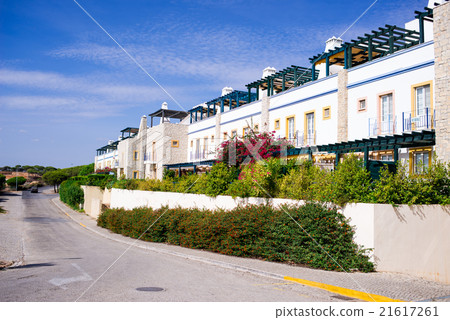 A nice street with white wall of the house 21617261