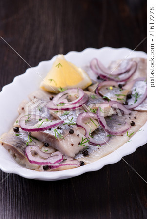 Sliced herring with pepper, herbs, salt, onion Sliced herring with pepper, herbs, salt, onion 21617278
