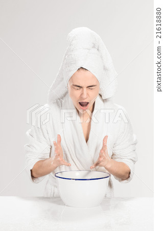 Young woman washing face with clean water Young woman washing face with clean water 21618880