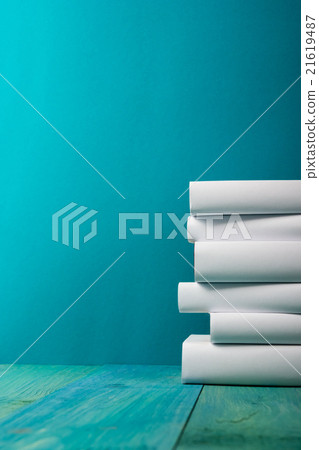 Stack of colorful books, grungy blue background Stack of colorful books, grungy blue background 21619487
