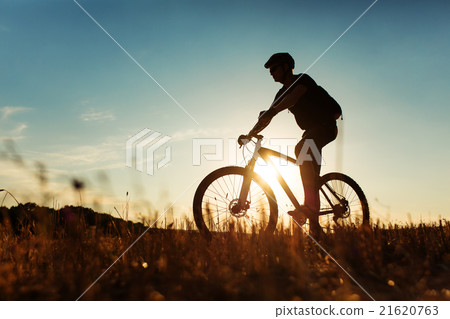 Man Cyclist with bike on sunset Man Cyclist with bike on sunset 21620763