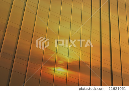 Reflection of sunset sky in metal wall of office 21621061