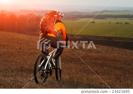 Man cyclist with backpack riding the bicycle 21621695