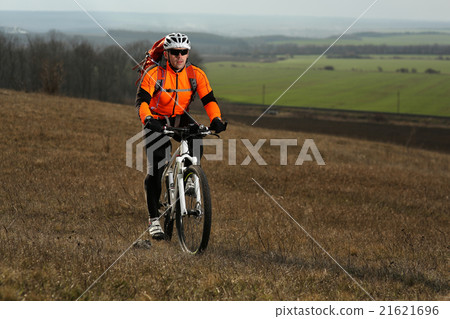 Man cyclist with backpack riding the bicycle 21621696