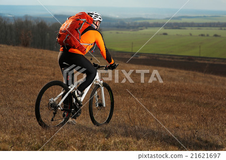 Man cyclist with backpack riding the bicycle 21621697