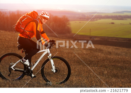 Man cyclist with backpack riding the bicycle Man cyclist with backpack riding the bicycle 21621779