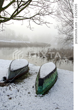 Two upturned boats on winter snow Two upturned boats on winter snow 21622995