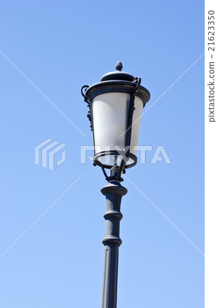 Vintage street lamp against blue sky 21623350