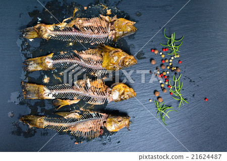 top view of fish skeleton bones and peppers top view of fish skeleton bones and peppers 21624487