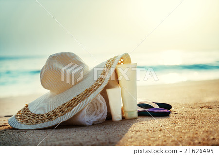 Sun lotion, hat  with bag at the tropical beach 21626495