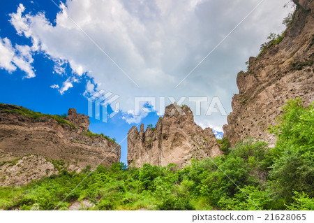 mountain cliffs and cloudy sky 21628065