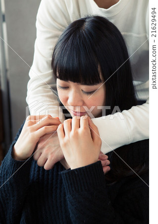 A woman hugging from behind A woman hugging from behind 21629494
