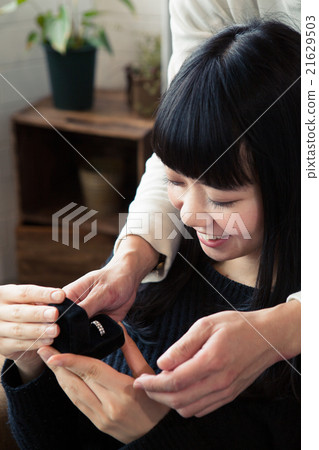 A woman who receives a present and smiles A woman who receives a present and smiles 21629503