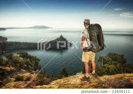 Hiker looks at sunrise 21630111