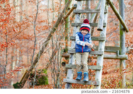 Cute little kid boy on autumn leaves background in Cute little kid boy on autumn leaves background in 21634876