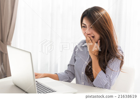 Beautifulwoman using laptop and is laughing 21638619