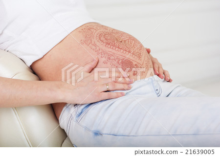 Pregnant belly with mehendi henna tattoo  21639005
