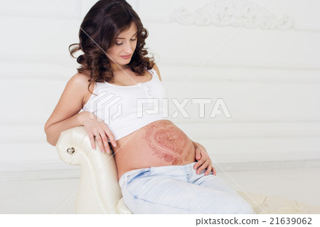 Pregnant girl with mehendi on her belly  21639062